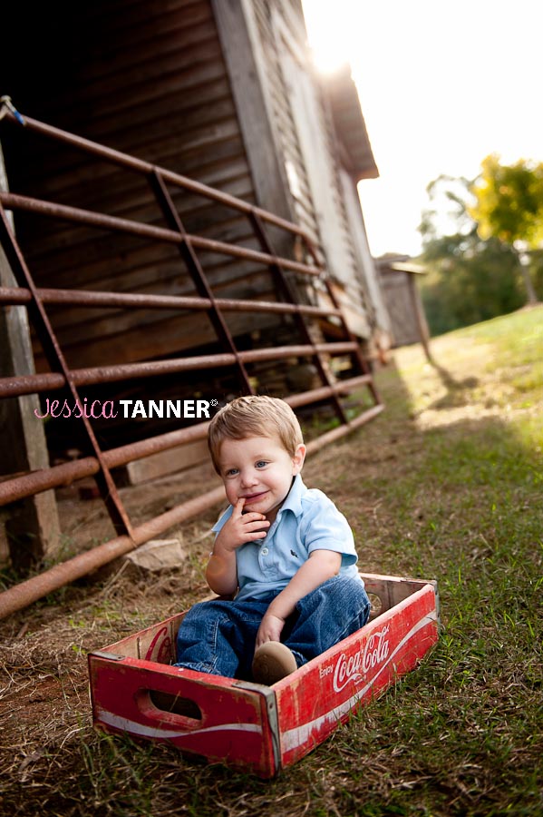 1 Year Old Boy sitting in coke crate on farm