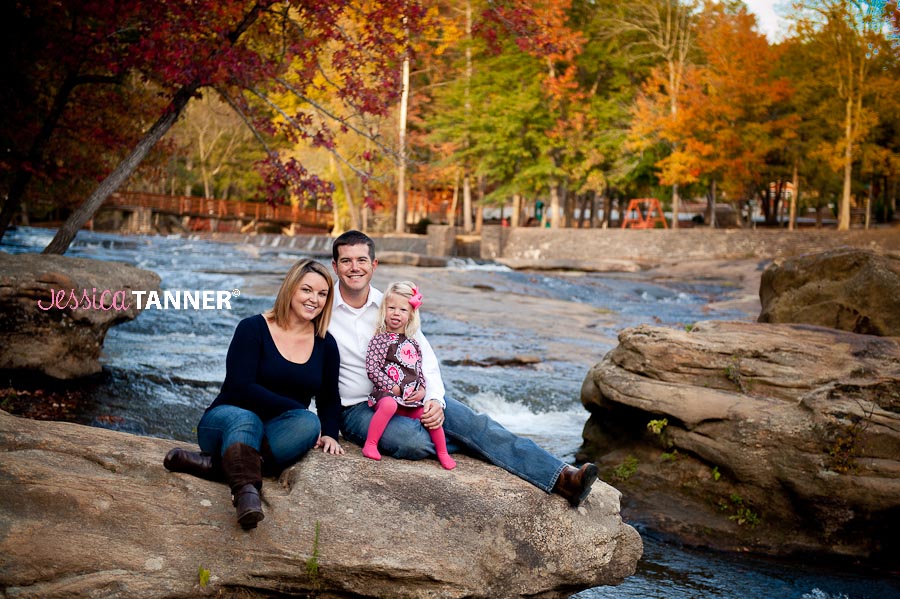 Family portrait on river rocks at the park